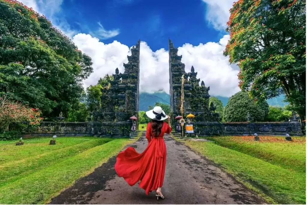 Girl in a red frock in front of Hindu Temple in Bali