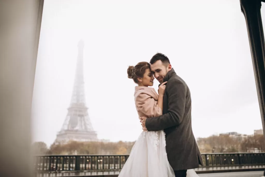 A couple in front of Eiffel tower.